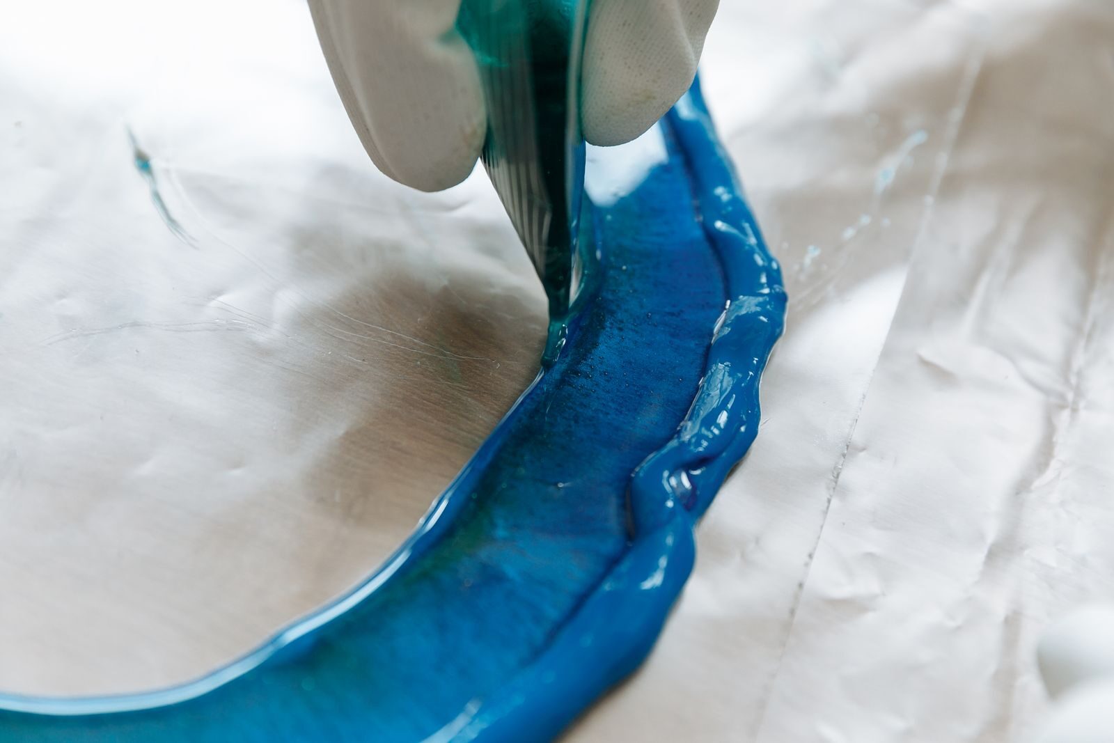 Detailed view of blue resin being poured in an art project, perfect for DIY crafts danville ca